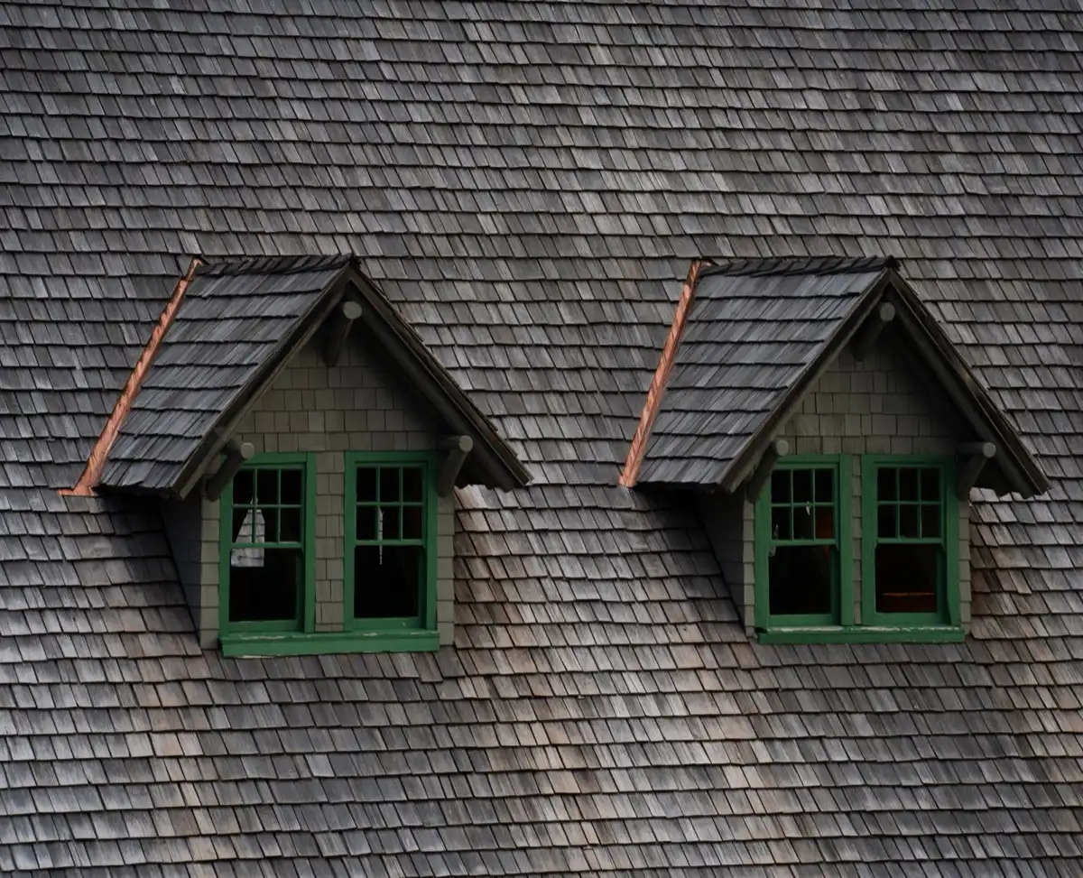 Dormers on a shingle roof in Redding, CA, where step flashing and kickout flashing carry water past the walls